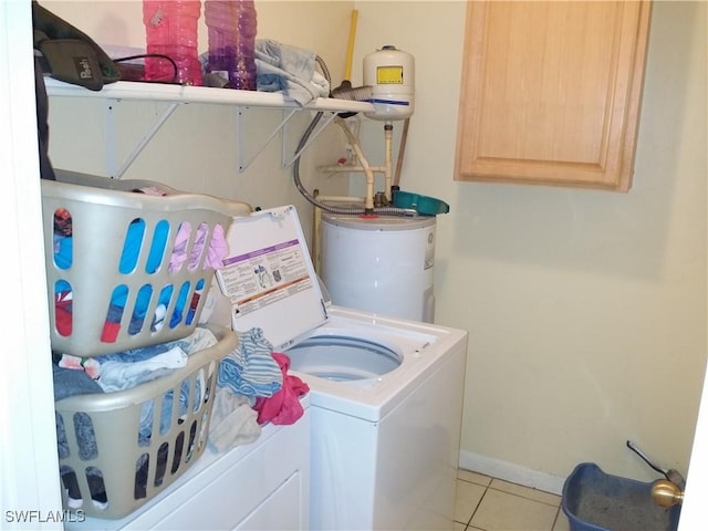 clothes washing area featuring separate washer and dryer, light tile patterned floors, and gas water heater