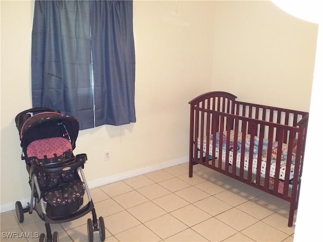 bedroom with tile patterned flooring and a crib