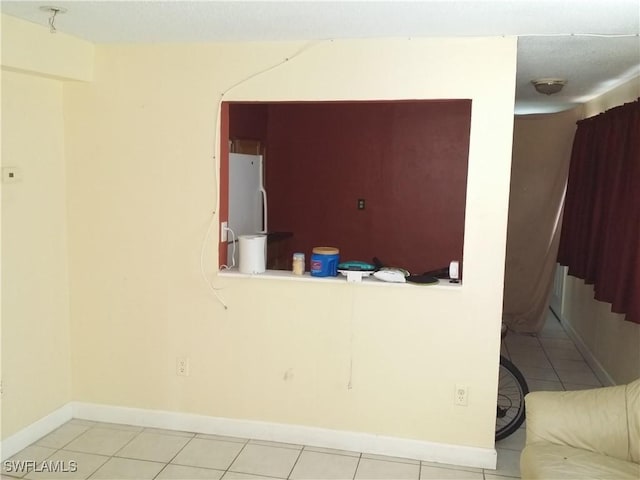 unfurnished room with light tile patterned floors