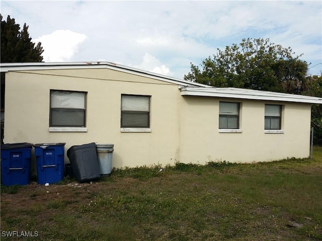 view of side of property with a yard