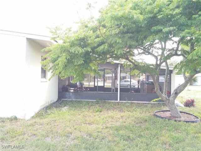 view of yard with a sunroom