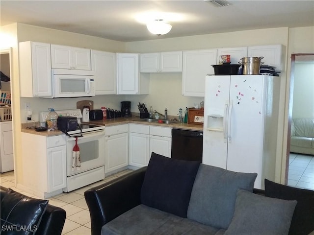 kitchen with white cabinetry, sink, light tile patterned floors, and white appliances