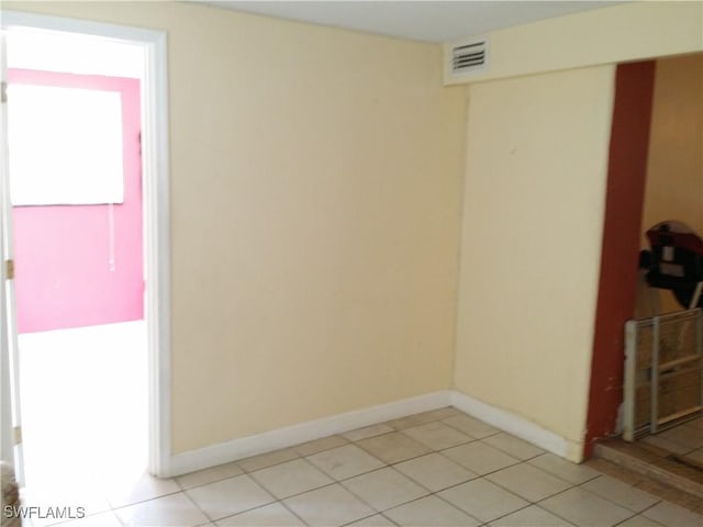 unfurnished room featuring light tile patterned flooring