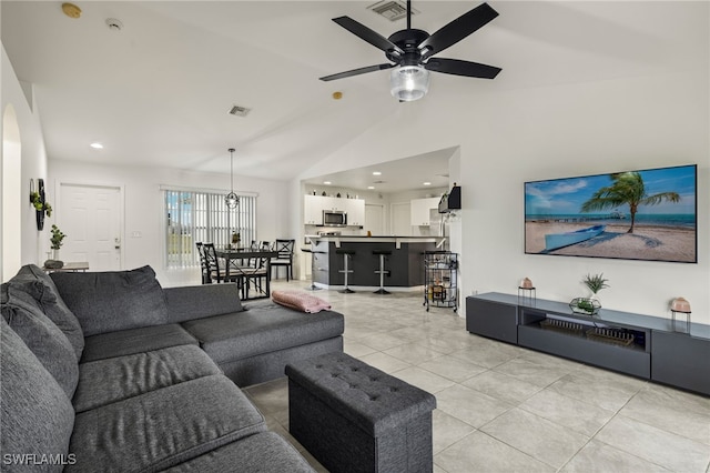 living room with ceiling fan and lofted ceiling