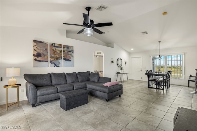 living room featuring vaulted ceiling and ceiling fan with notable chandelier