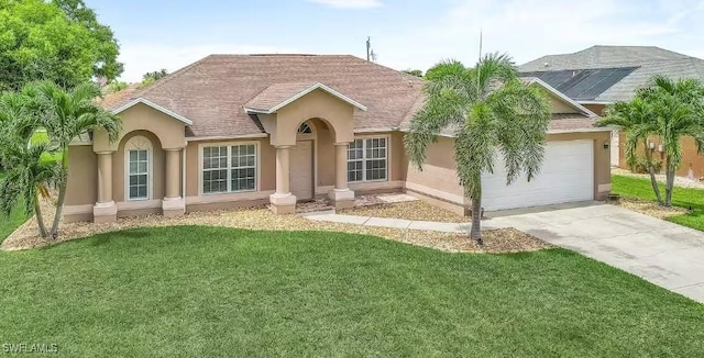 ranch-style home with stucco siding, a shingled roof, a garage, driveway, and a front lawn