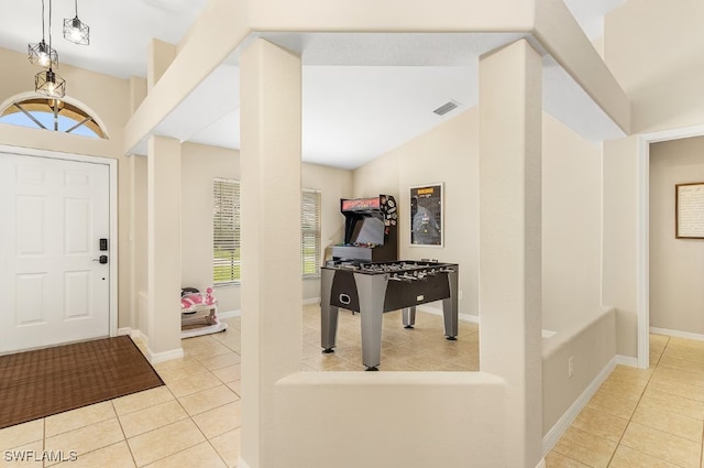 tiled foyer with vaulted ceiling