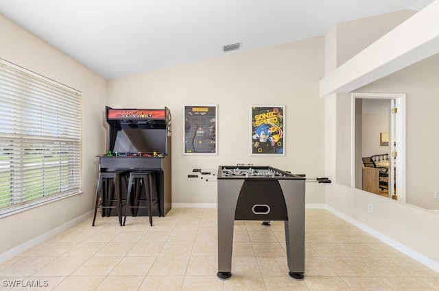 rec room with light tile patterned flooring and lofted ceiling