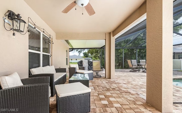 view of patio / terrace with outdoor lounge area, ceiling fan, and a lanai