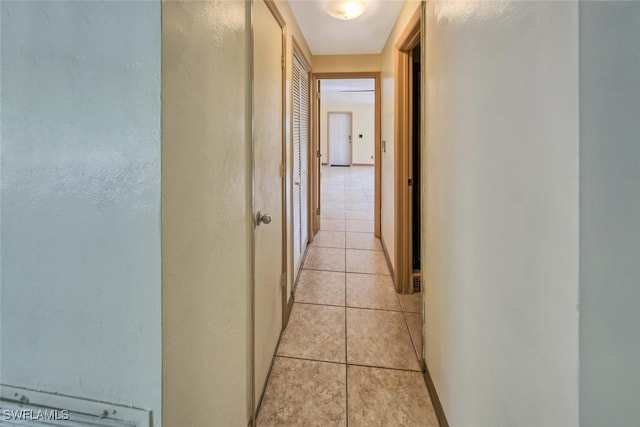 hall featuring light tile patterned floors