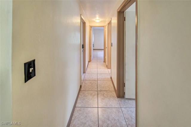 hall featuring light tile patterned floors