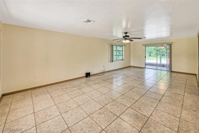 spare room with light tile patterned floors and ceiling fan