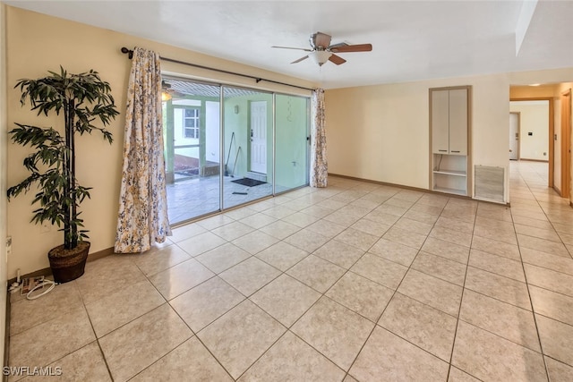 unfurnished room with light tile patterned floors and ceiling fan