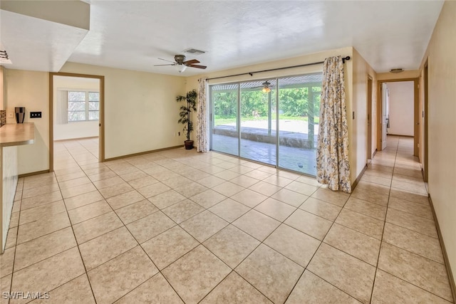 spare room featuring ceiling fan and light tile patterned flooring