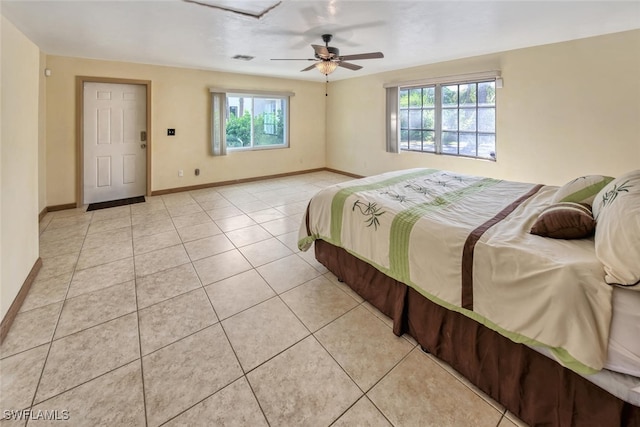 tiled bedroom with multiple windows and ceiling fan