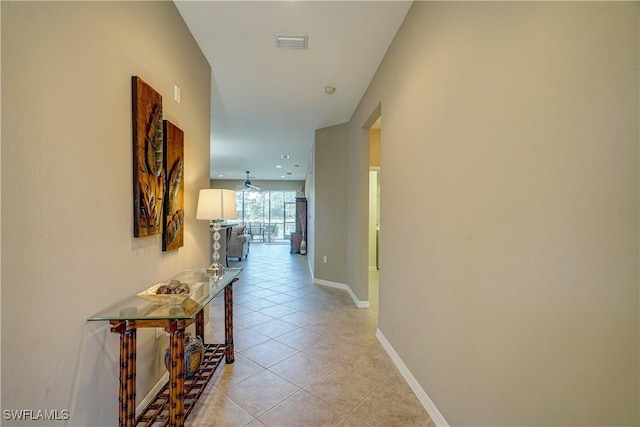 corridor featuring light tile patterned floors