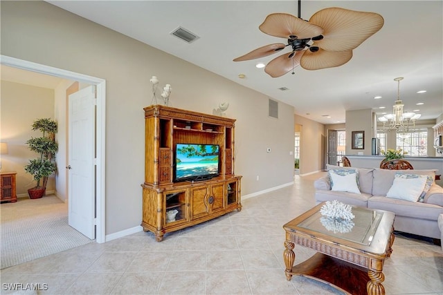 living room with light tile patterned floors and ceiling fan with notable chandelier