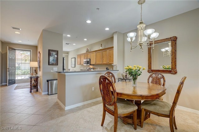 dining space featuring a notable chandelier and light tile patterned floors