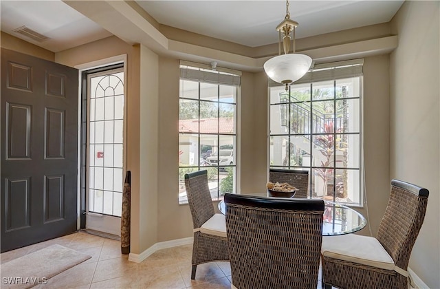 dining area featuring light tile patterned floors and a healthy amount of sunlight