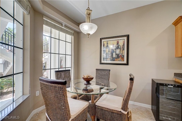 dining room with beverage cooler, light tile patterned floors, and a wealth of natural light