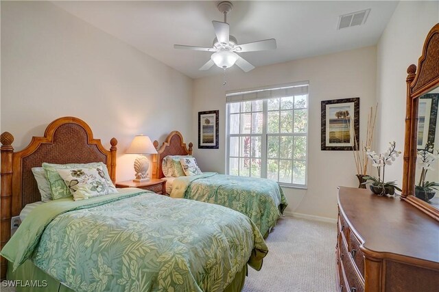 carpeted bedroom featuring ceiling fan and multiple windows