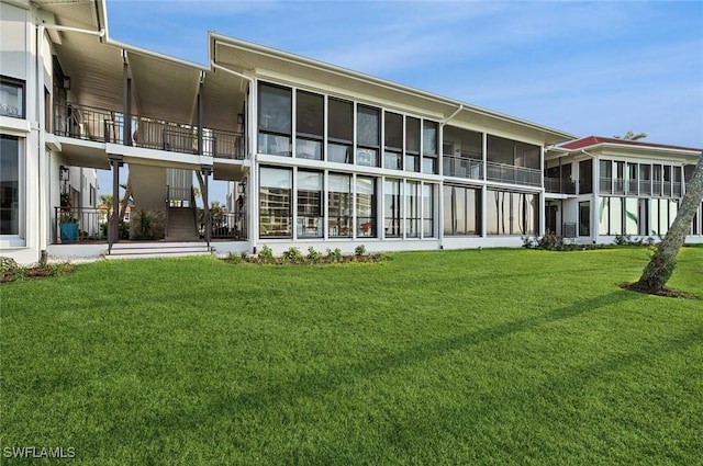 2246 Gulf Shore Blvd N Unit L2, Naples, FL 34102 - rear view of house featuring a lawn and a sunroom