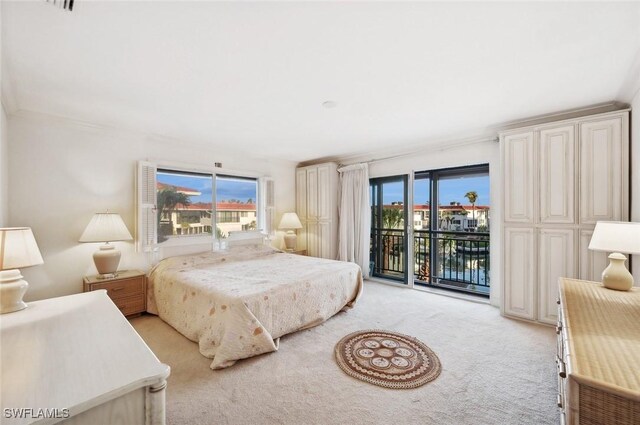 bedroom with access to outside and light colored carpet