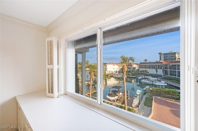 interior space with ornamental molding and a water view