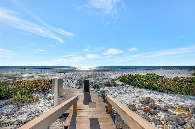 exterior space featuring a water view and a view of the beach