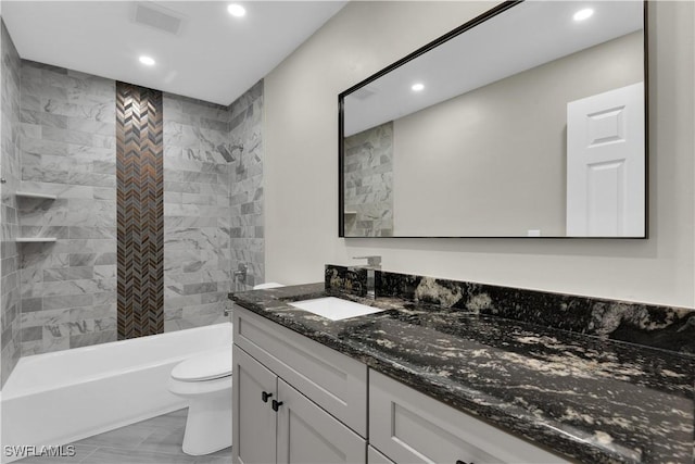 full bathroom with vanity, toilet, and tiled shower / bath