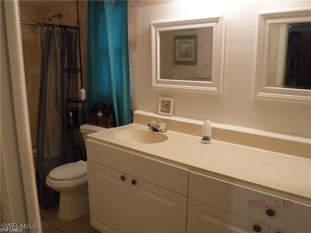 bathroom with a shower with curtain, tile patterned flooring, vanity, and toilet