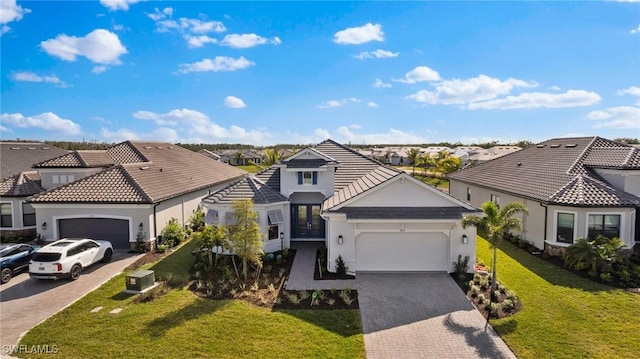 view of front of home with a front lawn and a garage