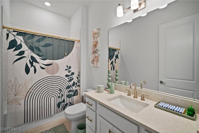 bathroom featuring toilet, vanity, and tile patterned floors