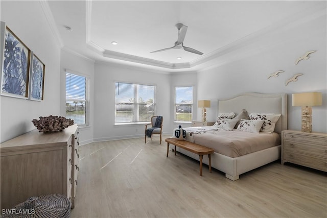 bedroom featuring a raised ceiling, ceiling fan, crown molding, and light hardwood / wood-style flooring