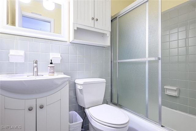 bathroom featuring vanity, a shower with shower door, and toilet