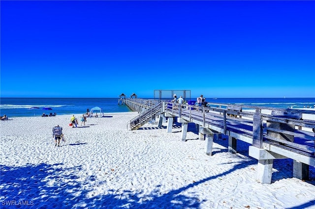 exterior space featuring a beach view and a water view