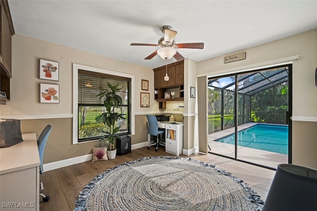 office with ceiling fan and dark wood-type flooring