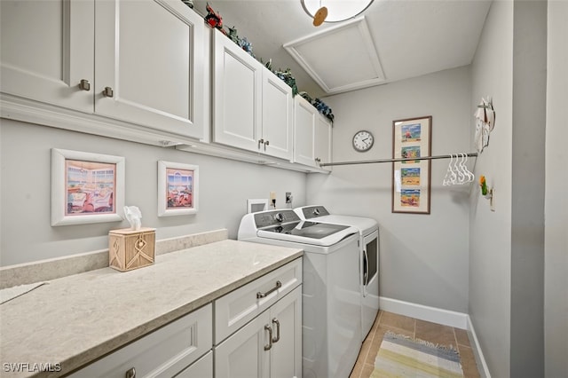 laundry area with washer and clothes dryer, light tile patterned flooring, and cabinets