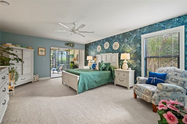 bedroom featuring access to exterior, light colored carpet, and ceiling fan