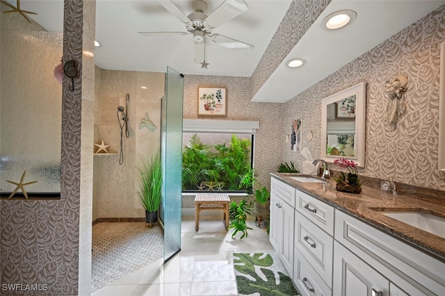 bathroom with a tile shower, tile patterned floors, vanity, and ceiling fan