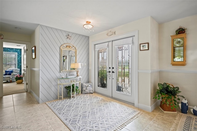 entryway featuring french doors and light tile patterned flooring