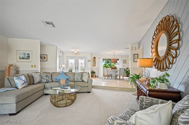 living room with french doors and light colored carpet