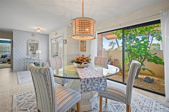 tiled dining area featuring a notable chandelier