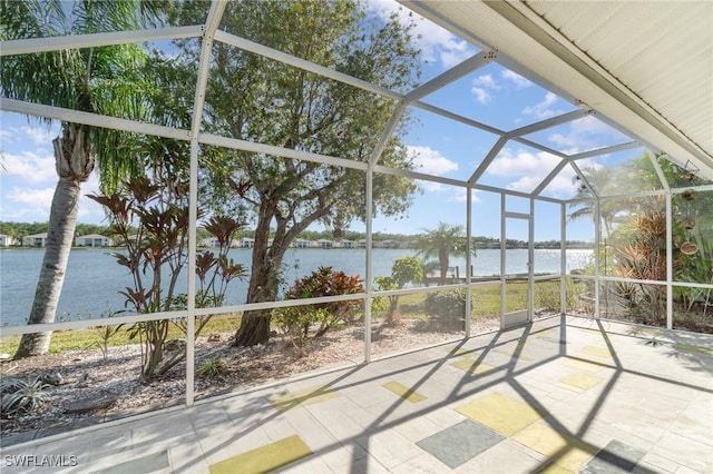 view of patio / terrace with glass enclosure and a water view