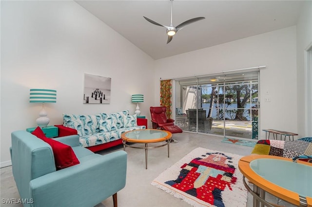 living room featuring ceiling fan, high vaulted ceiling, and concrete flooring