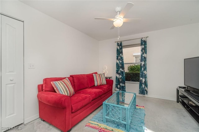 living room with ceiling fan and concrete floors