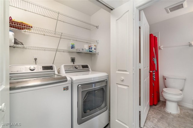 clothes washing area featuring washer and clothes dryer