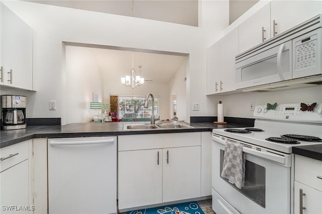 kitchen with white cabinetry, sink, white appliances, and an inviting chandelier