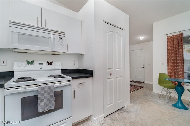 kitchen with white appliances and white cabinetry