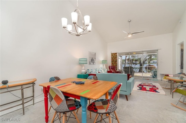 carpeted dining space featuring high vaulted ceiling and ceiling fan with notable chandelier